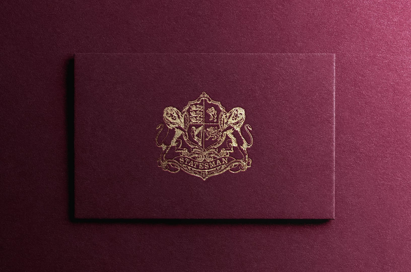 An image showing the Statesman Rail branding, gold foiled onto burgundy card